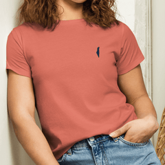 Model wearing a coral Classic Tee with a dark Promise State chest logo, styled with blue jeans.