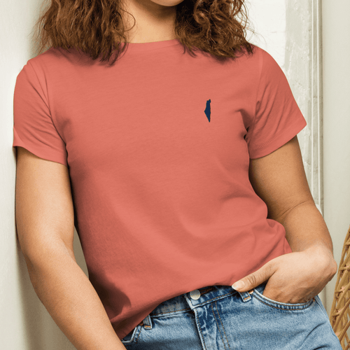 Model wearing a coral Classic Tee with a dark Promise State chest logo, styled with blue jeans.